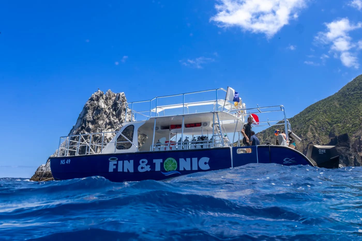 Sea Saba dive boat Fin & Tonic moored beside Diamond Rock off Saba.
