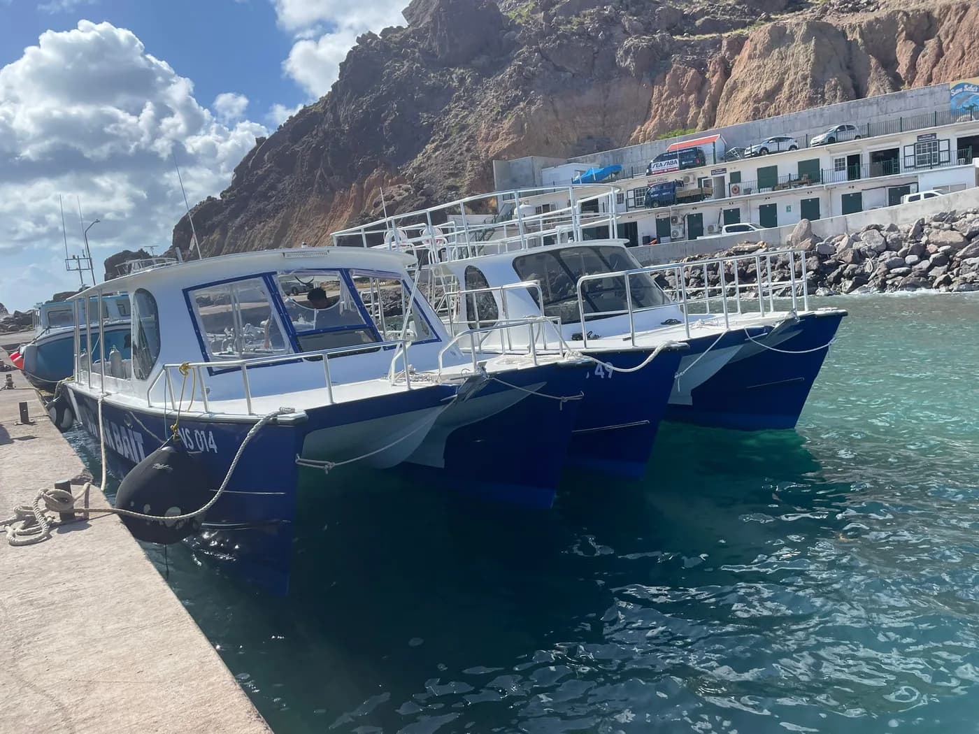 Two Sea Saba custom dive catamarans moored at Fort Bay Harbor, Saba