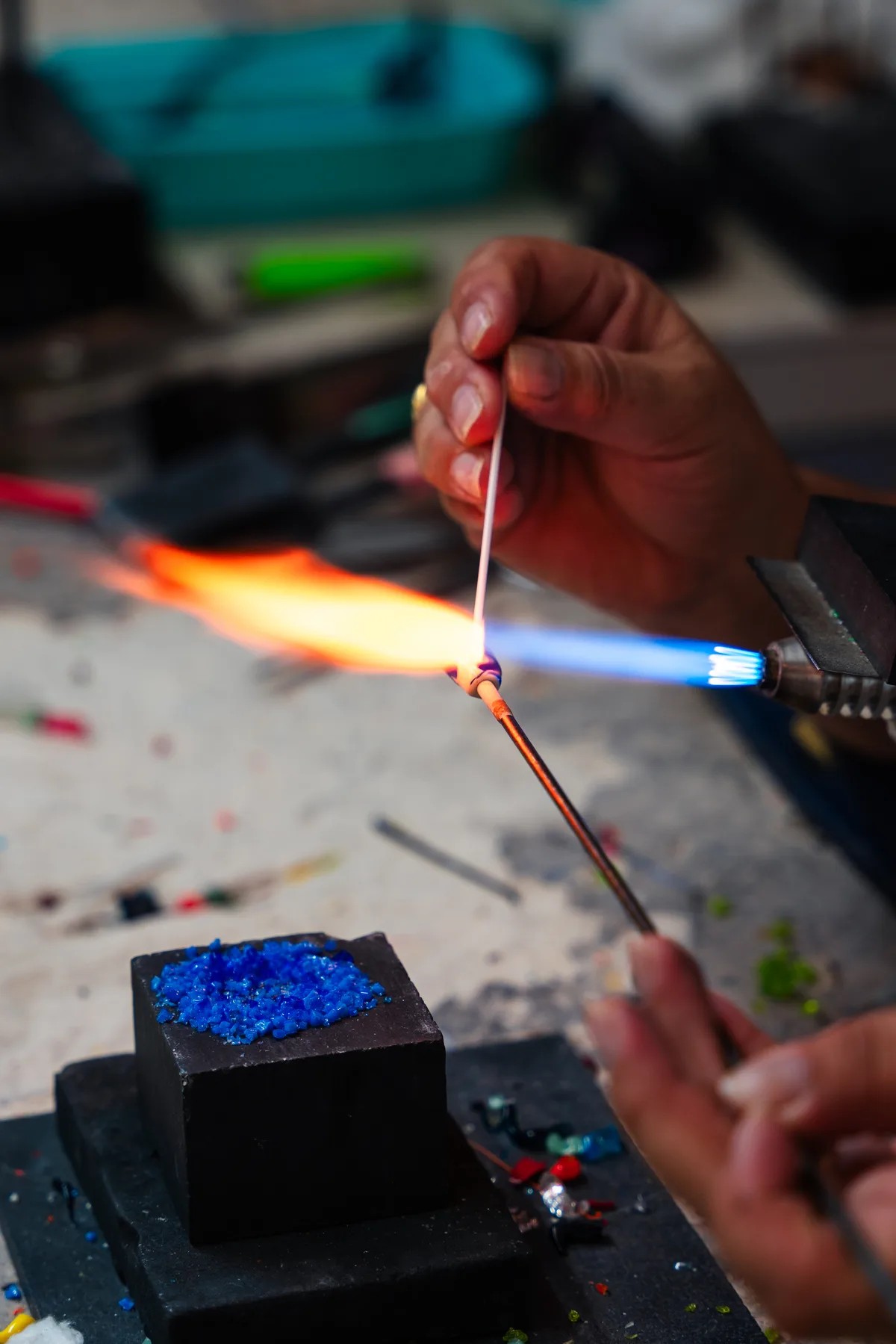 Glass artist shaping molten glass into handmade art