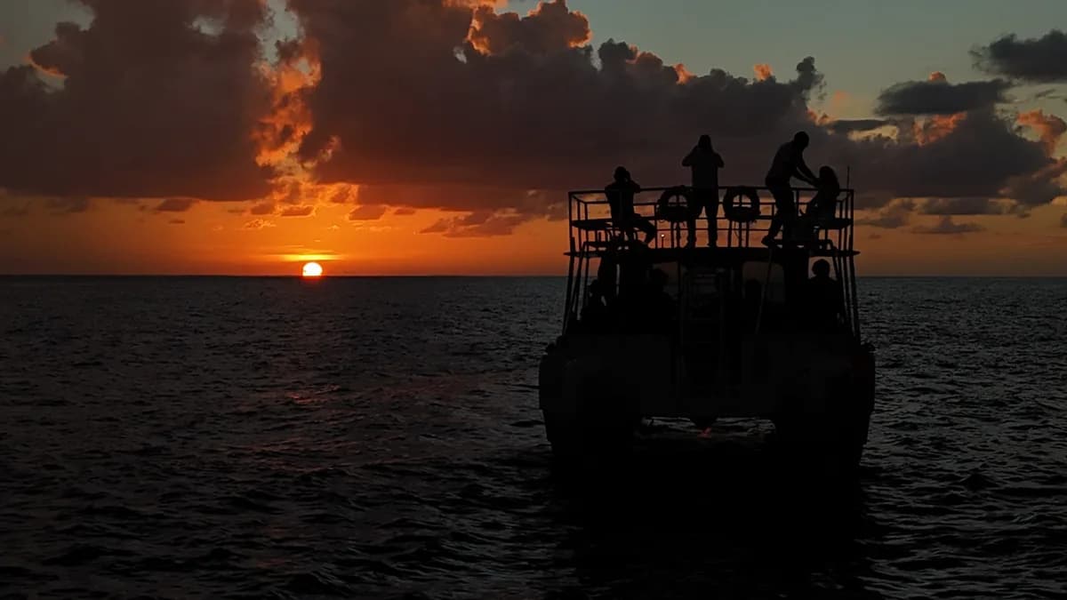 Guests watching the sunset from the deck of a Sea Saba boat off Saba's coast
